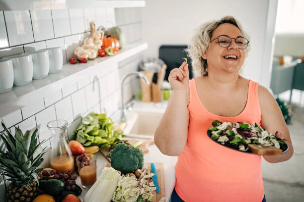 Overweight women preparing food in kitchen