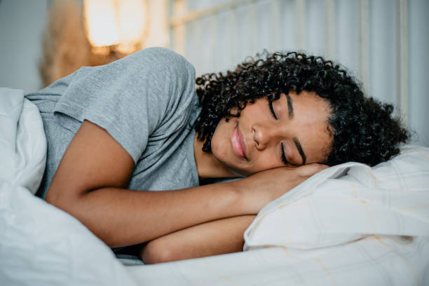 teenager sleeping in bed