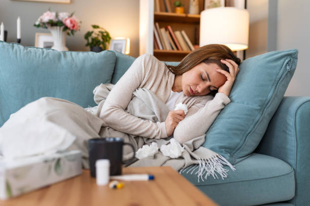 Cold And Flu. Portrait Of Ill Woman Caught Cold, Feeling Sick And Sneezing In Paper Wipe. Closeup Of Beautiful Unhealthy Girl Covered In Blanket Wiping Nose. Healthcare Concept.